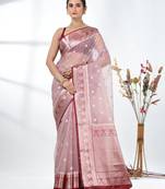 nude pink organza saree with floral motifs and blue border