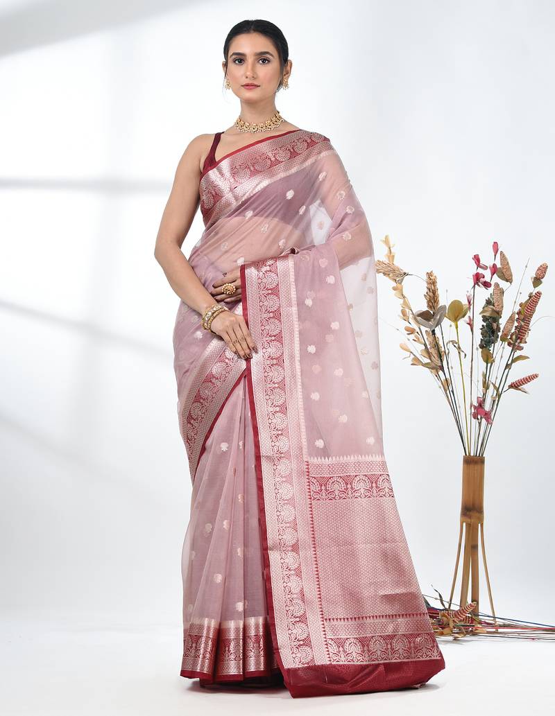 nude pink organza saree with floral motifs and blue border