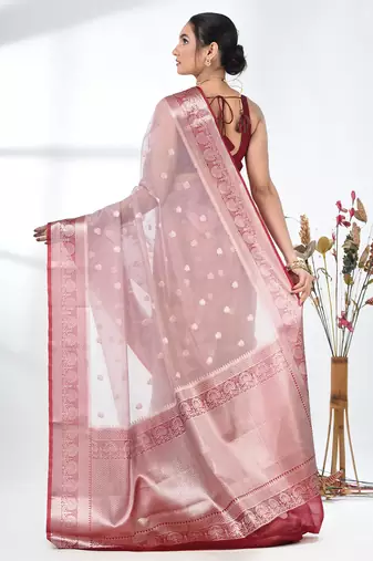 nude pink organza saree with floral motifs and blue border