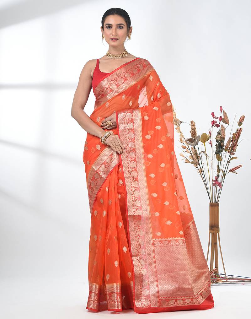 orange organza saree with floral motifs and sea green border