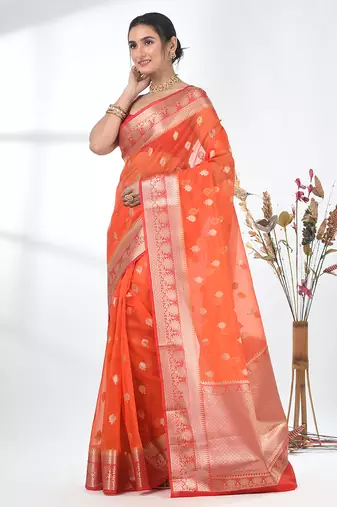 orange organza saree with floral motifs and sea green border