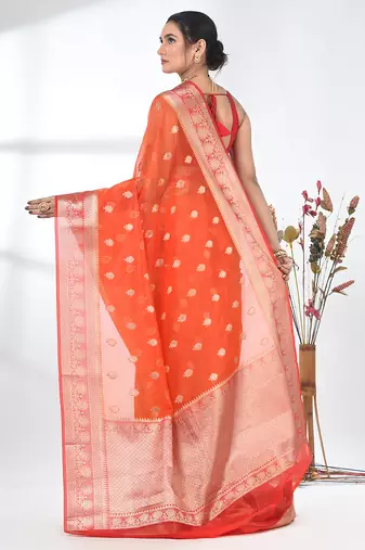 orange organza saree with floral motifs and sea green border