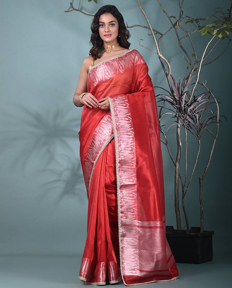 red tissue saree with intricate silver zari border