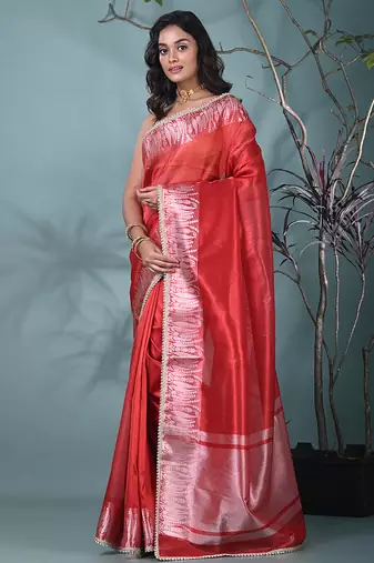 red tissue saree with intricate silver zari border