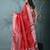 red tissue saree with intricate silver zari border