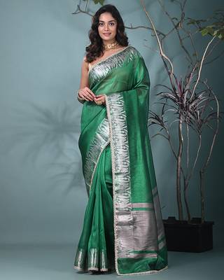 green tissue saree with intricate silver zari border 1