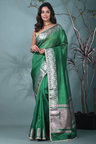 green tissue saree with intricate silver zari border