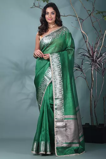 green tissue saree with intricate silver zari border