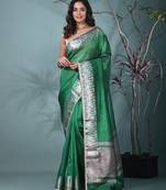 green tissue saree with intricate silver zari border