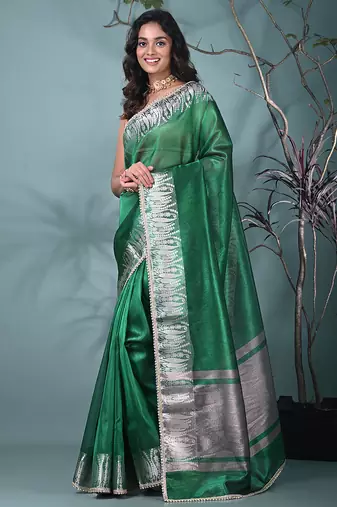 green tissue saree with intricate silver zari border