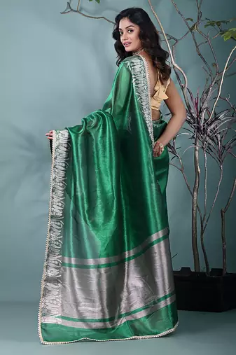 green tissue saree with intricate silver zari border