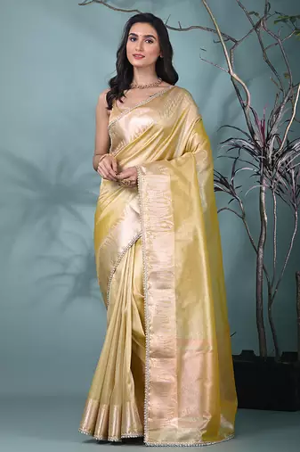 yellow tissue saree with intricate silver zari border