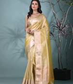 yellow tissue saree with intricate silver zari border