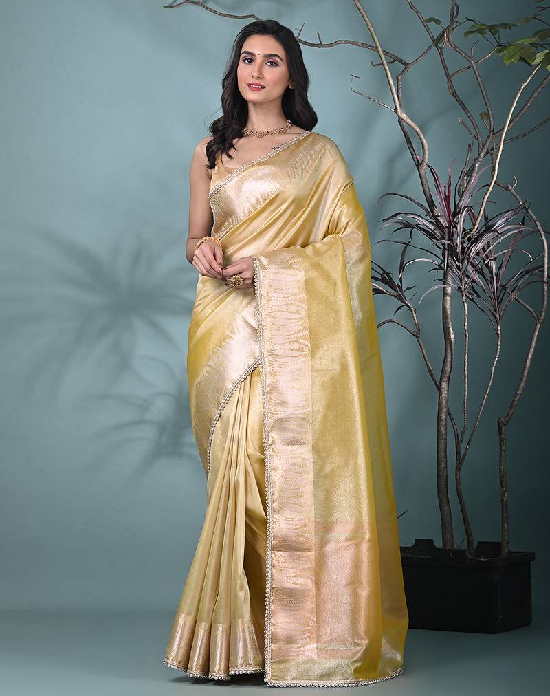 yellow tissue saree with intricate silver zari border