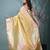 yellow tissue saree with intricate silver zari border