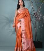 orange tissue saree with intricate silver zari border