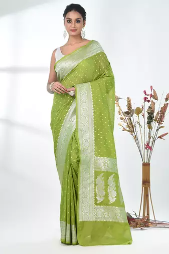 green georgette saree with silver border and detailing