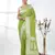 green georgette saree with silver border and detailing