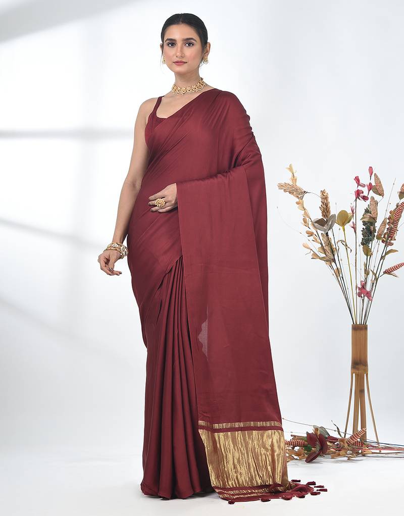 maroon modal silk blend saree with golden border and tassels