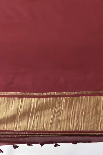 maroon modal silk blend saree with golden border and tassels