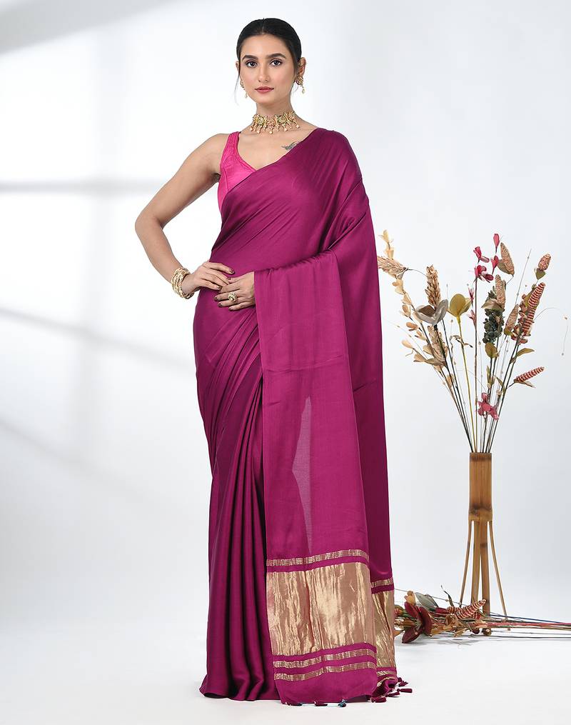 magenta modal silk blend saree with golden border and tassels