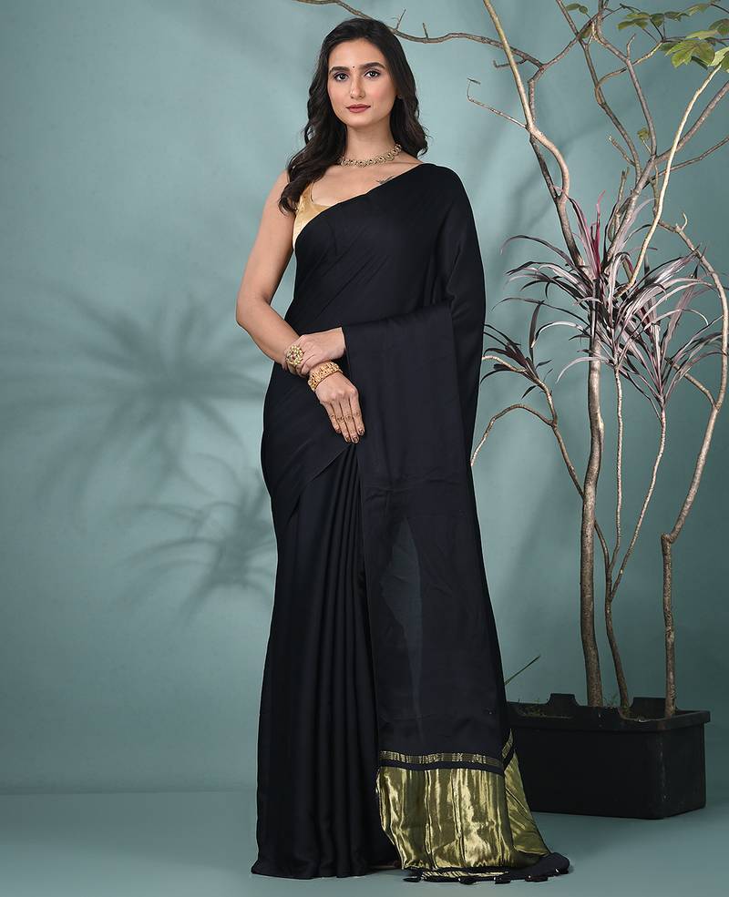 black modal silk blend saree with golden border and tassels