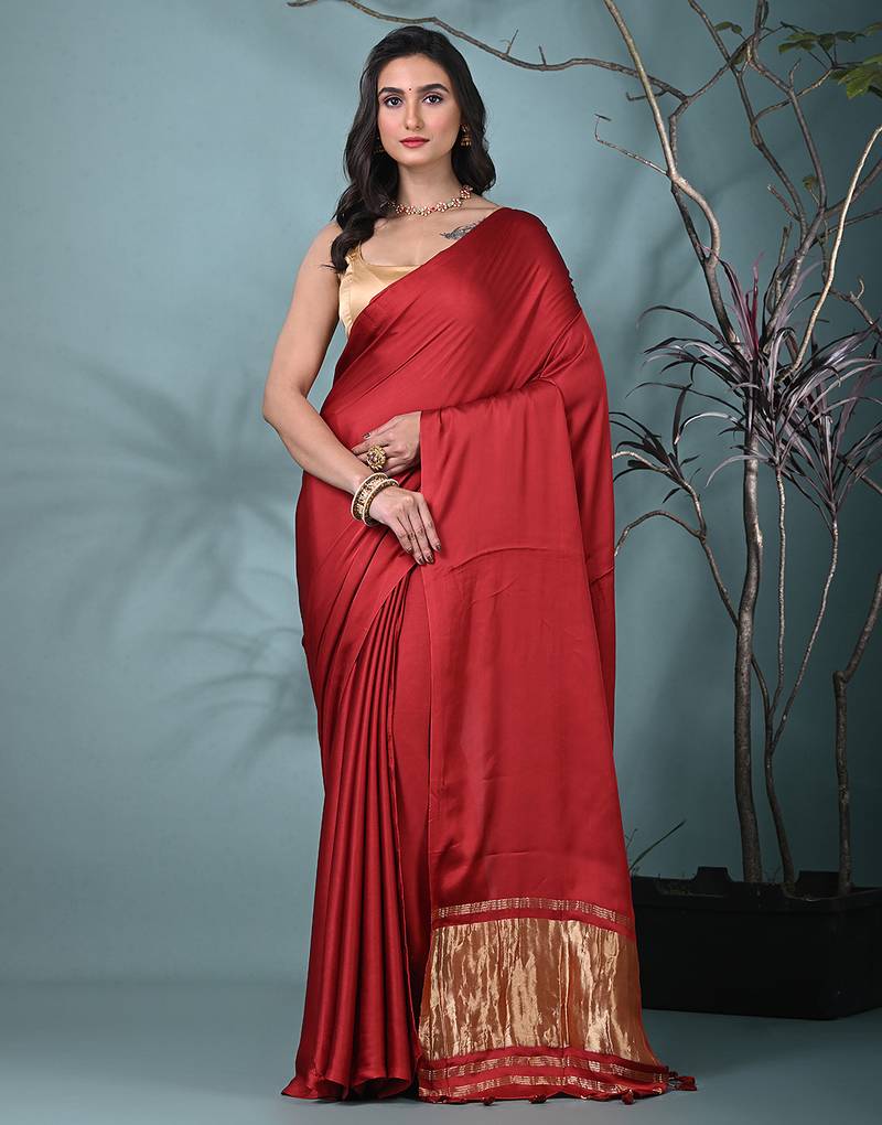 red modal silk blend saree with golden border and tassels