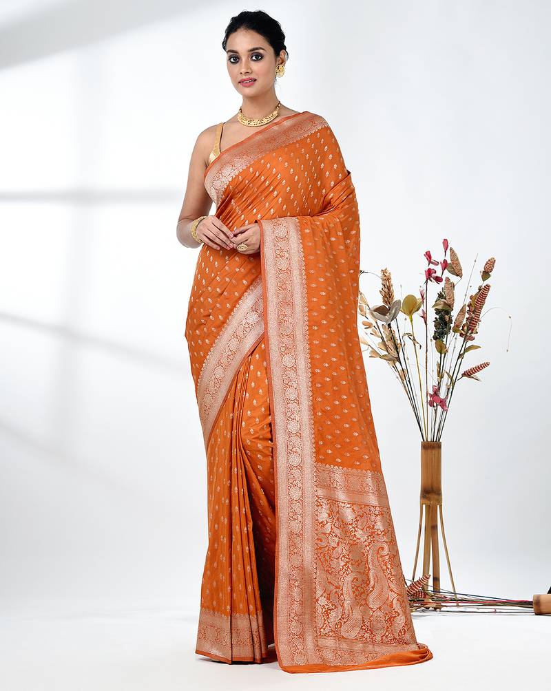 elegant orange georgette saree with intricate silver zari work