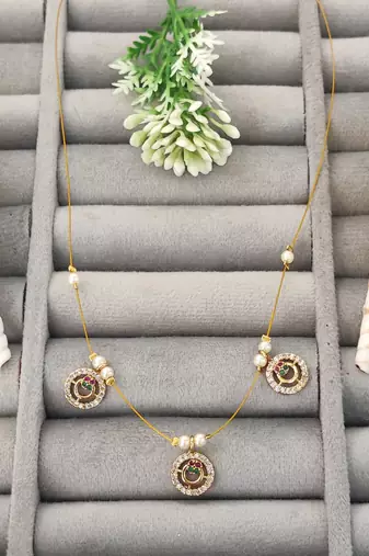 Invisible gold-plated triple pendant necklace with pearl detailing