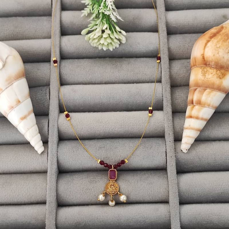 Invisible lightweight ruby bead chain necklace with gold temple pendant