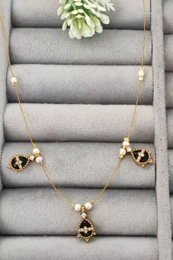 Invisible gold-plated green pendant necklace with pearls for festive wear