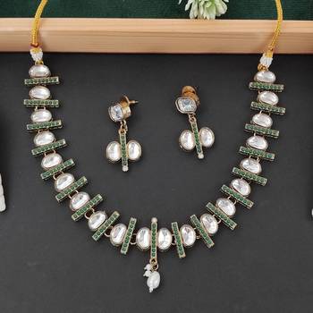 kundan necklace set with green accents and pearl detailing 1