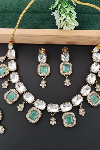 kundan style necklace set with emerald green stones, polki finish, matching earrings,