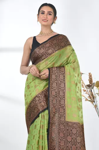 green georgette saree with red and gold border