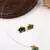 Minimal green lotus motif pendant set with invisible chain
