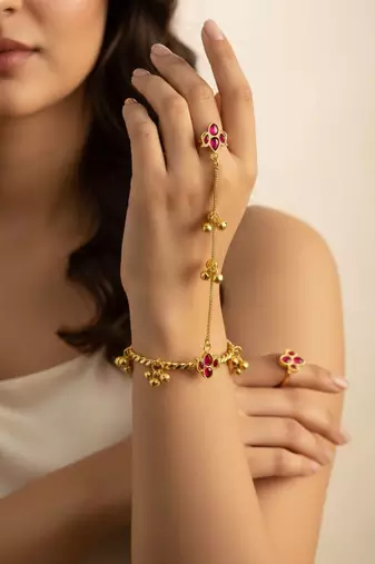 gold-plated kundan floral hathphool with ruby stones