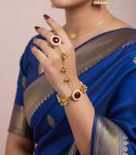 gold-plated kundan floral hathphool with ruby stones