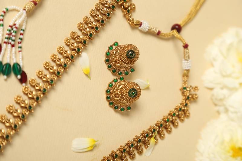 gold plated necklace set with emerald green stones