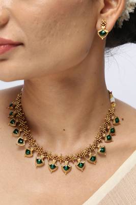 gold plated necklace set with emerald leaf motifs 1
