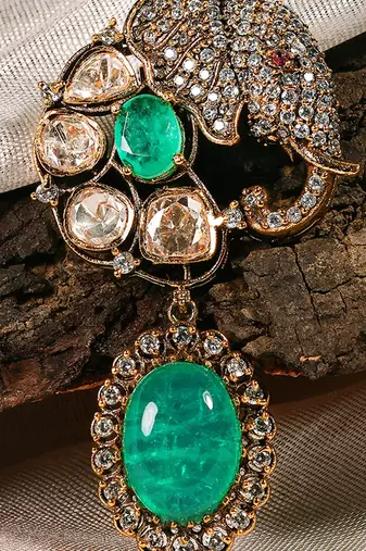 Gold plated kundan green stones brooch