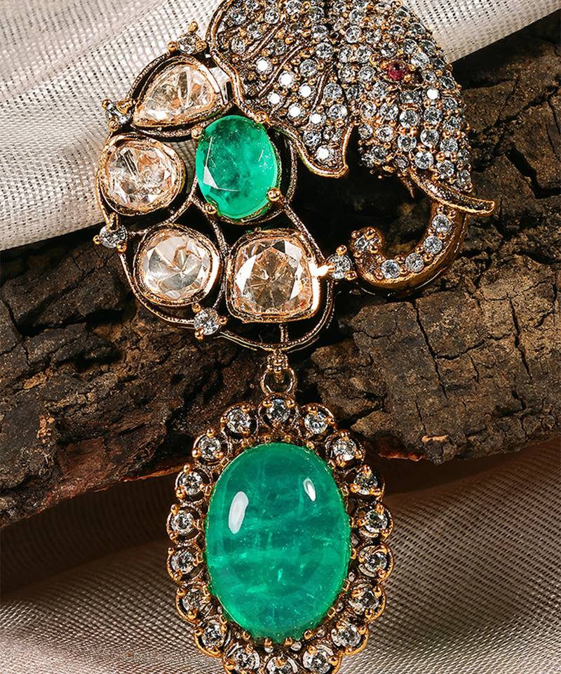 Gold plated kundan green stones brooch