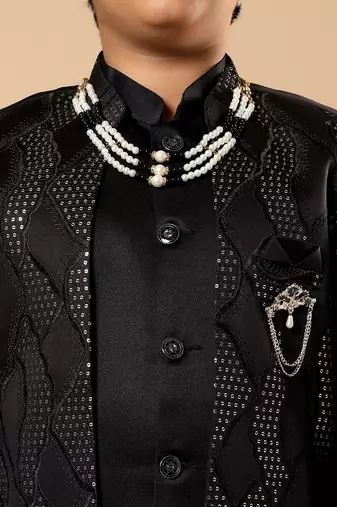 Boys black satin wavy embroidered sequined sherwani & trouser set with shrug and necklace