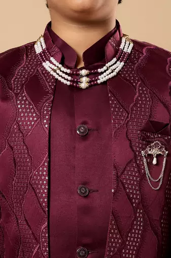 Boys burgundy satin wavy embroidered sequined sherwani & trouser set with shrug and necklace