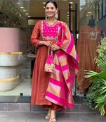 Women rust anarkali kurta with pink dupatta