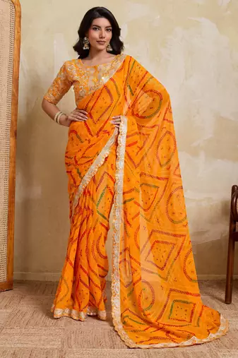 Enchanting yellow georgette bandhej print with cutwork lace border saree with mono banglory silk blouse