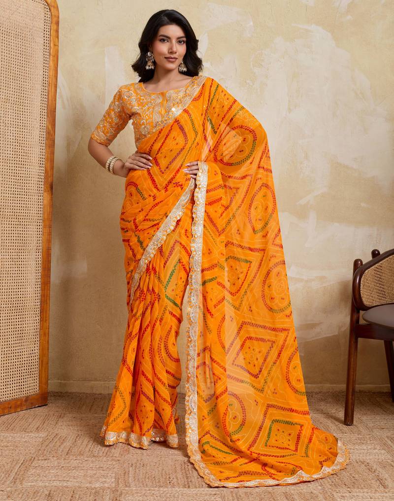 Enchanting yellow georgette bandhej print with cutwork lace border saree with mono banglory silk blouse