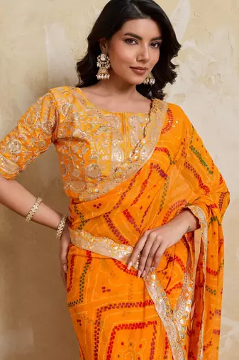 Enchanting yellow georgette bandhej print with cutwork lace border saree with mono banglory silk blouse
