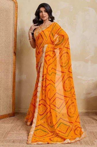 Enchanting yellow georgette bandhej print with cutwork lace border saree with mono banglory silk blouse