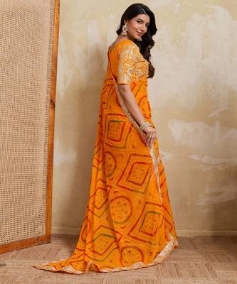 Enchanting yellow georgette bandhej print with cutwork lace border saree with mono banglory silk blouse 4