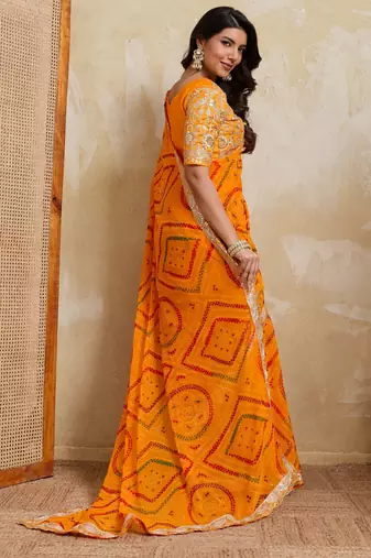 Enchanting yellow georgette bandhej print with cutwork lace border saree with mono banglory silk blouse